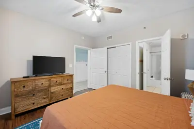 a bedroom with a bed and a flat screen tv at Laketown Wharf #333 by Nautical Properties in Panama City Beach