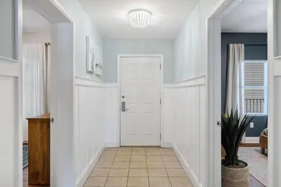 a hallway with a white door and a potted plant at Laketown Wharf #333 by Nautical Properties in Panama City Beach