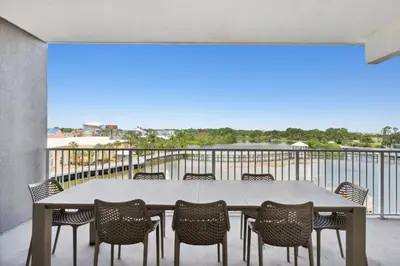 a table and chairs on a balcony with a view at Laketown Wharf #333 by Nautical Properties in Panama City Beach