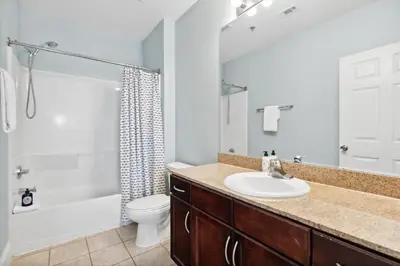 a bathroom with a sink and a toilet and a shower at Laketown Wharf #2136 by Nautical Properties in Panama City Beach