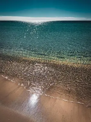 a beach with the ocean and the shoreline at Laketown Wharf #1628 by Nautical Properties in Panama City Beach