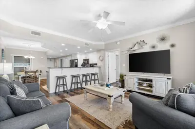 a living room with a couch and a tv at Treasure Island #1008 in Panama City Beach