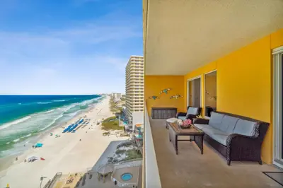 a view of the beach from the balcony of a building at Treasure Island #1008 in Panama City Beach