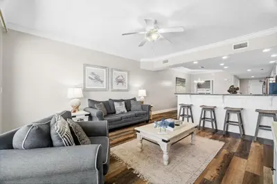 a living room with a couch and a table at Treasure Island #1008 in Panama City Beach
