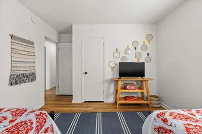 a bedroom with a tv on a table in front of a door at Stylish 3BR 2BA House Minutes from PCB - Book now in Panama City