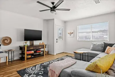 a living room with a couch and a flat screen tv at Stylish 3BR 2BA House Minutes from PCB - Book now in Panama City