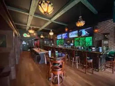a bar in a restaurant with bar stools and televisions at Stylish 3BR 2BA House Minutes from PCB - Book now in Panama City