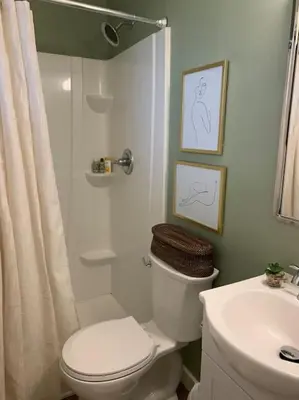a bathroom with a toilet and a shower and a sink at Stylish 3BR 2BA House Minutes from PCB - Book now in Panama City