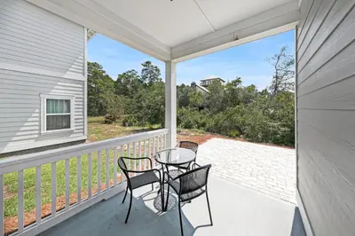a balcony with two chairs and a table on it at Grande Pointe Sea Shell in Inlet Beach