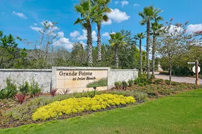 a sign for a park with palm trees and flowers at Grande Pointe Sea Shell in Inlet Beach
