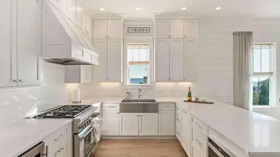 a white kitchen with white cabinets and a sink at 30A Beach Therapy in Inlet Beach