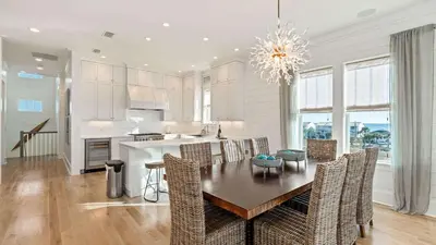 a kitchen and dining room with a table and chairs at 30A Beach Therapy in Inlet Beach