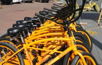 a row of yellow bikes parked on a street at 30A Beach Therapy in Inlet Beach