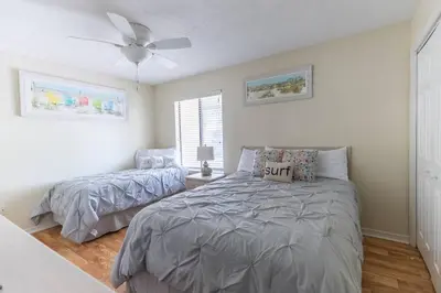 a bedroom with a bed and a ceiling fan at Spacious Family Hideaway on the Emerald Coast! in Panama City Beach