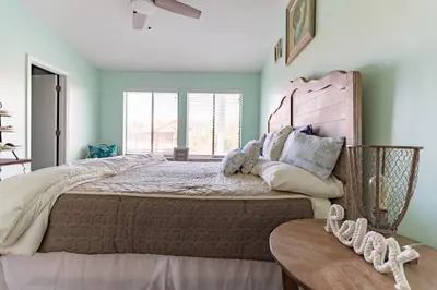 a large bed in a room with green walls at Spacious Family Hideaway on the Emerald Coast! in Panama City Beach
