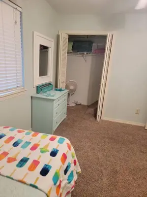 a bedroom with a bed and a dresser and a mirror at 188WSD in Panama City Beach