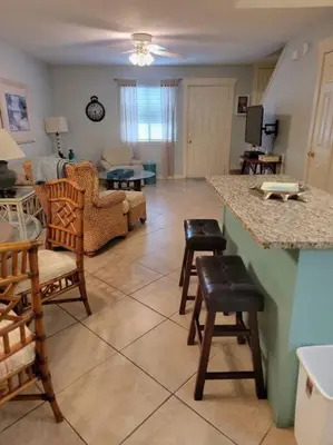 a kitchen and living room with chairs and a table at 188WSD in Panama City Beach