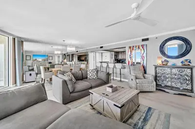 a living room with couches and a table at Long Beach Resort 1-904 in Panama City Beach
