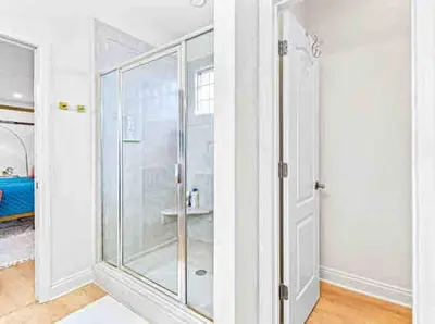 a bathroom with a shower with a glass door at Luxurious 4BR Beach House with Pool in Panama City Beach