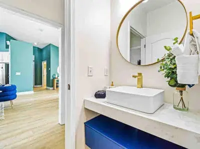 a bathroom with a white sink and a mirror at Luxurious 4BR Beach House with Pool in Panama City Beach