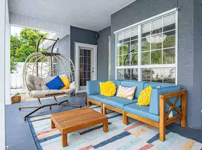 a living room with a blue couch and a table at Luxurious 4BR Beach House with Pool in Panama City Beach