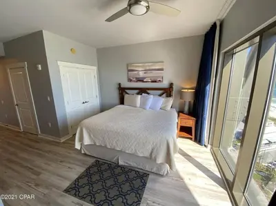 a bedroom with a bed and a ceiling fan at Beautiful Beach Condo - luxury living at its best in Panama City Beach