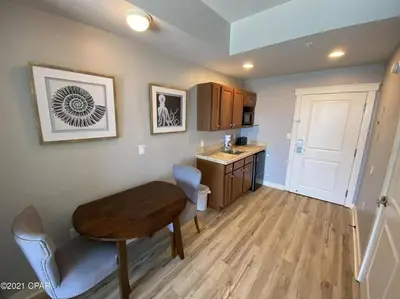 a kitchen with a desk and a table in a room at Beautiful Beach Condo - luxury living at its best in Panama City Beach