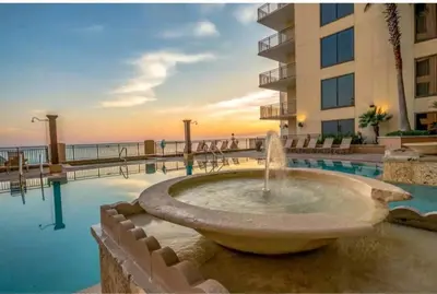 a fountain in front of a building with the ocean at Beautiful Beach Condo - luxury living at its best in Panama City Beach