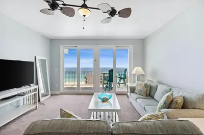 a living room with a couch and a tv at Laketown Wharf #1509 by Nautical Properties in Panama City Beach