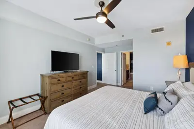 a bedroom with a bed and a flat screen tv at Laketown Wharf #1509 by Nautical Properties in Panama City Beach