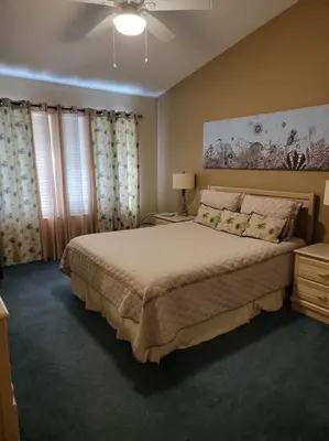 a bedroom with a large bed and a ceiling fan at Gulf Highlands 230 WSD in Panama City Beach
