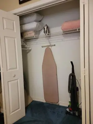 a room with a closet with a skateboard and towels at Gulf Highlands 230 WSD in Panama City Beach
