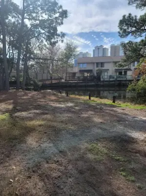a large yard with a building in the background at Gulf Highlands 230 WSD in Panama City Beach