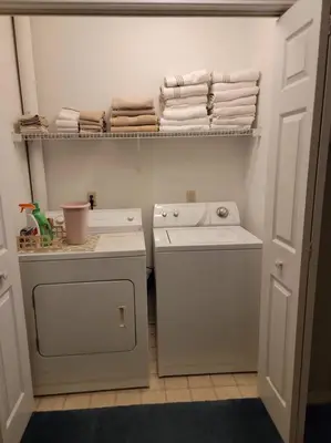 a laundry room with a washing machine and towels at Gulf Highlands 230 WSD in Panama City Beach