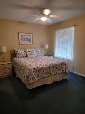 a bedroom with a bed and a ceiling fan at Gulf Highlands 230 WSD in Panama City Beach