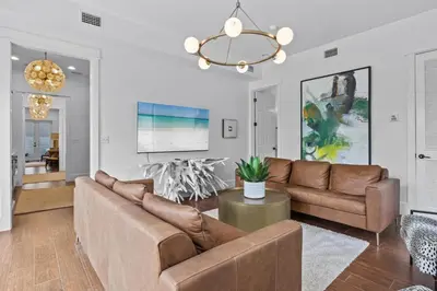 a living room with a couch and a chandelier at Gulf Views, Large Private Pool, 30A, Two Kitchens in Seacrest