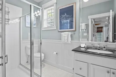 a white bathroom with a toilet and a sink at Gulf Views, Large Private Pool, 30A, Two Kitchens in Seacrest
