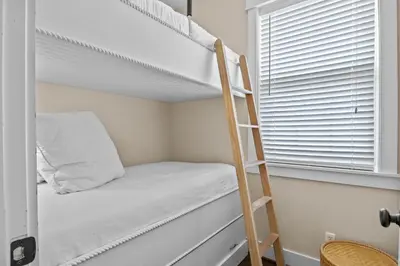 a bunk bed with a ladder next to a window at Gulf Views, Large Private Pool, 30A, Two Kitchens in Seacrest