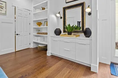 a hallway with white cabinets and a mirror at Gulf Views, Large Private Pool, 30A, Two Kitchens in Seacrest