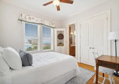 a white bedroom with a bed and a window at Cozy Beach House (4 min walk) w/Pool + Fast WiFi in Panama City Beach