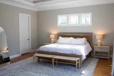 a bedroom with a bed and two tables and two lamps at Cozy Beach House (4 min walk) w/Pool + Fast WiFi in Panama City Beach