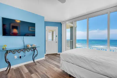 a bedroom with a bed with a view of the ocean at Long Beach Resort 3-404 in Panama City Beach