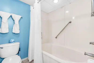 a bathroom with a tub and a toilet and a shower at Long Beach Resort 3-404 in Panama City Beach