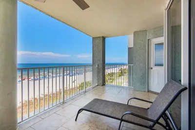 a balcony with a chair and a view of the ocean at Long Beach Resort 3-404 in Panama City Beach