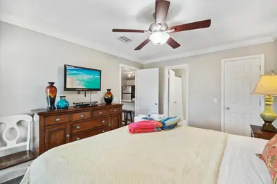 a bedroom with a bed and a ceiling fan at Seaspray Hideaway Sleeps 8 Pools Beach Access in Panama City Beach