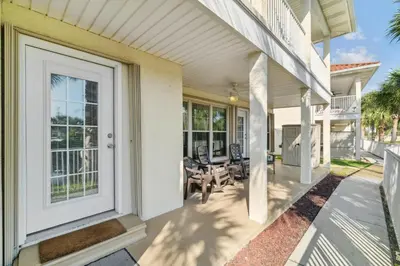 a front porch of a home with a white door at Seaspray Hideaway Sleeps 8 Pools Beach Access in Panama City Beach