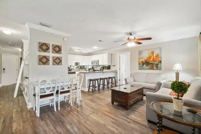 a living room with a couch and a table at Seaspray Hideaway Sleeps 8 Pools Beach Access in Panama City Beach