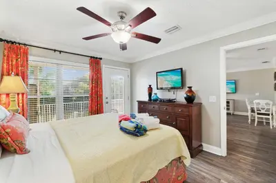 a bedroom with a bed and a ceiling fan at Seaspray Hideaway Sleeps 8 Pools Beach Access in Panama City Beach