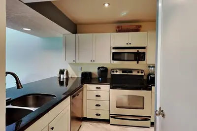 a kitchen with white cabinets and a sink at Edgewater Villa #2007 in Panama City Beach