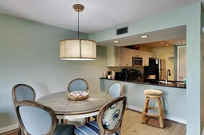 a kitchen and dining room with a table and chairs at Edgewater Villa #2007 in Panama City Beach